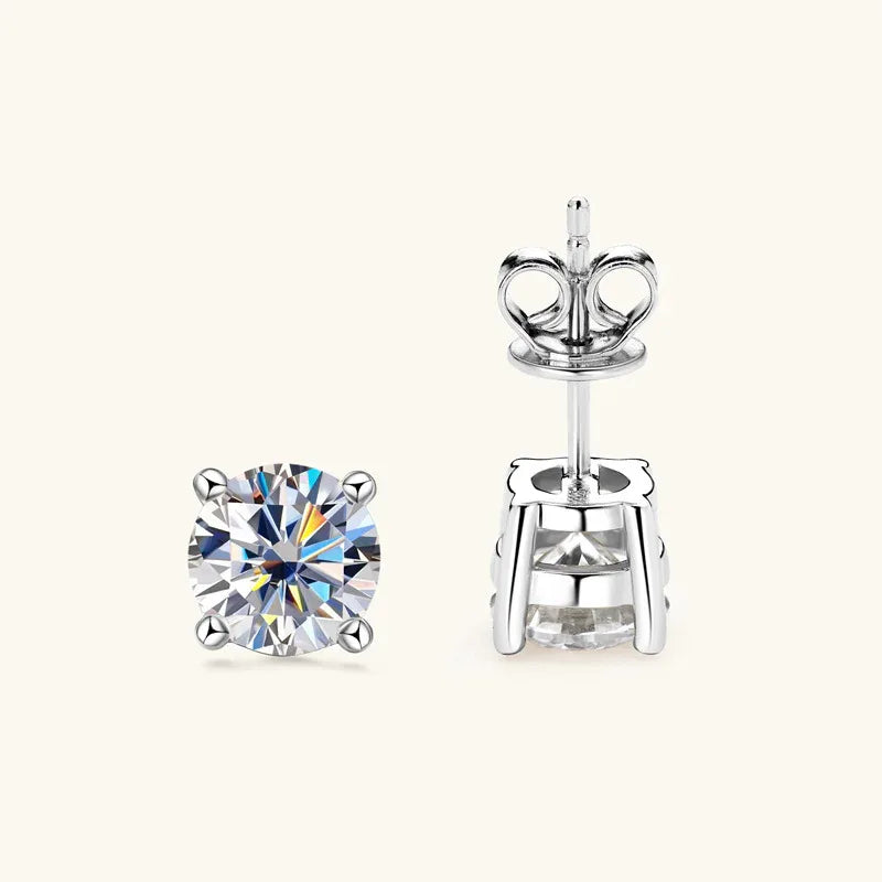 Round moissanite stud earrings in silver-tone metal with prong setting and back clips