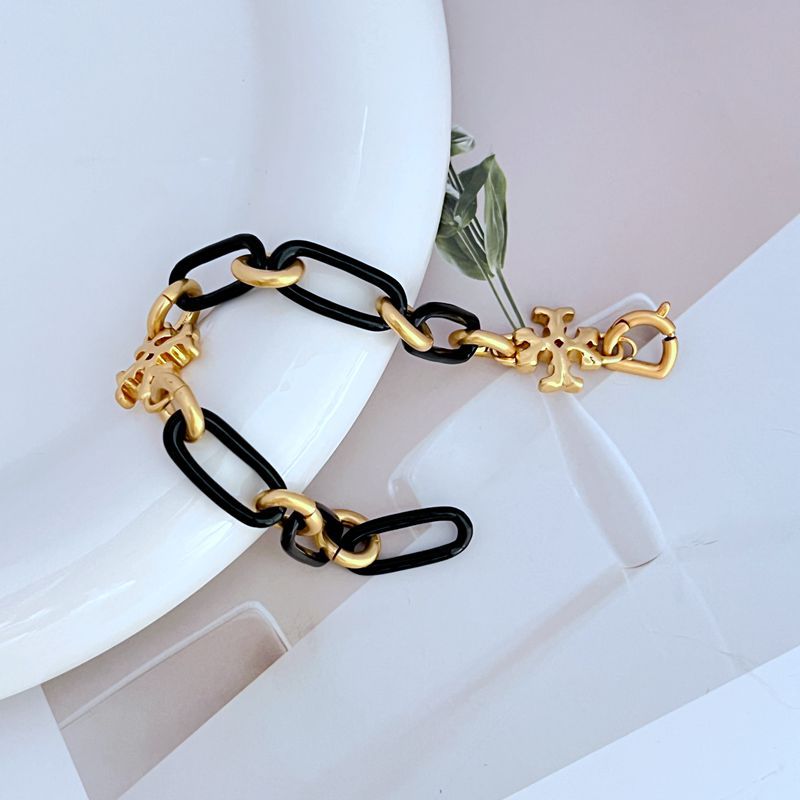 Black chunky chain bracelet with gold logo charms and linked metal clasp