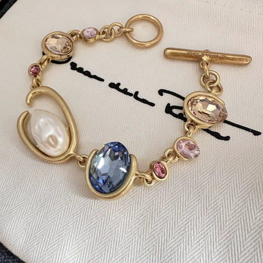 Gold-tone crystal and pearl O-ring bracelet with blue and pink oval stones