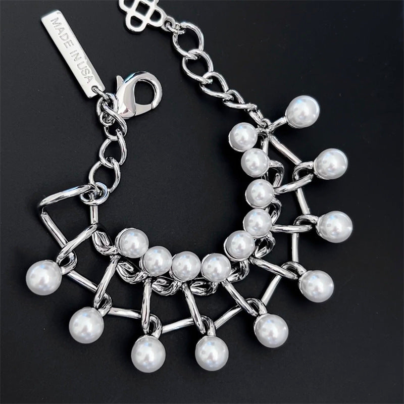 Silver intertwined link pearl bracelet with round pearls and dangling chain clusters