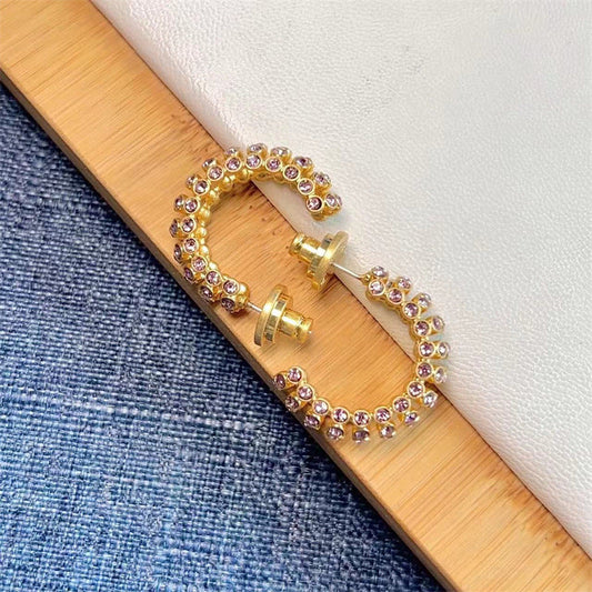 Gold-tone hoop earrings with purple cubic zirconia stones