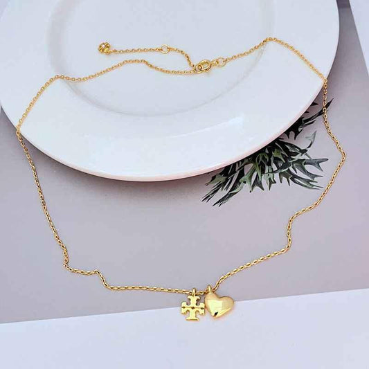 Gold metal heart pendant necklace with link chain and small heart logo charm at center
