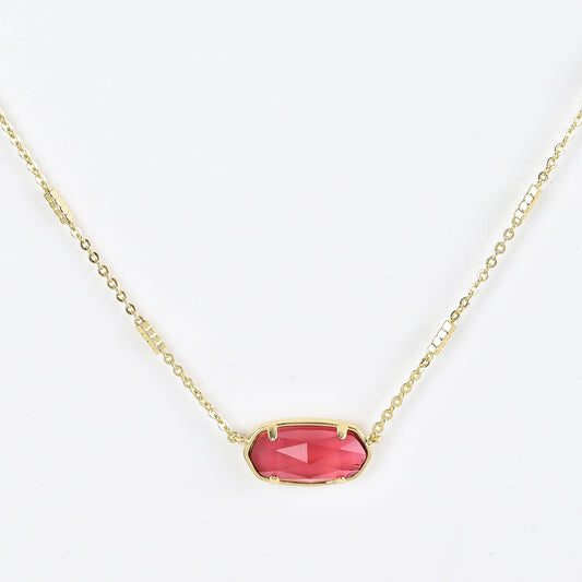 Oval crystal pendant necklace with pink stone and gold bezel on a gold chain