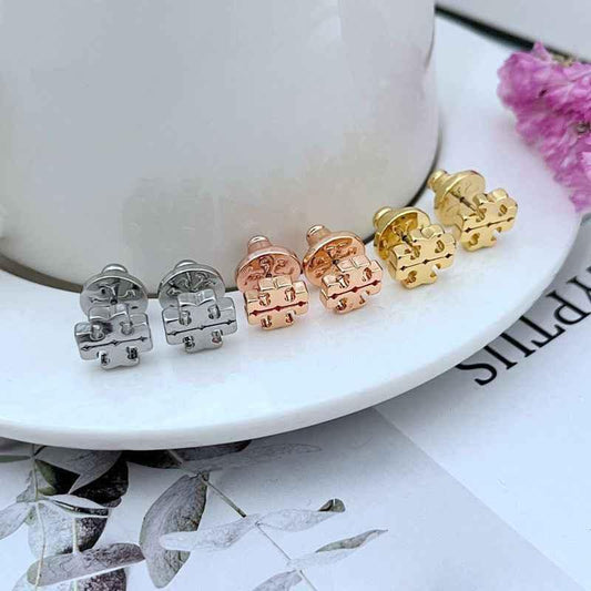 Logo stud earrings set in silver, rose gold, and gold-tone, round backs shown