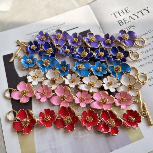 Multicolor enamel floral bracelet with blue, pink, and red petals and gold-tone frames