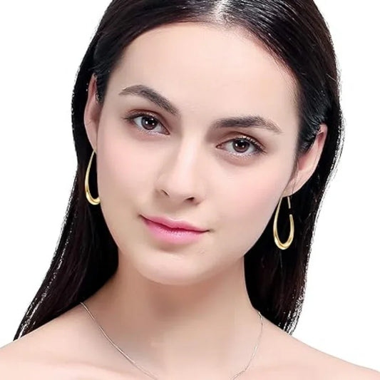 Gold teardrop hoop earrings on the ear, curved teardrop metal hoops with open top