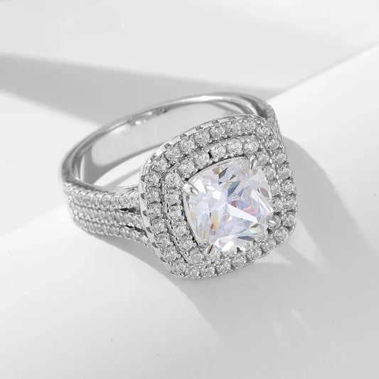 Silver cushion-cut CZ ring with side micro-inlaid pave stones, oval halo setting