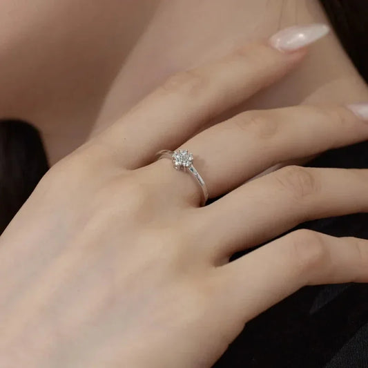 Silver CZ flower ring on finger with clustered round stones