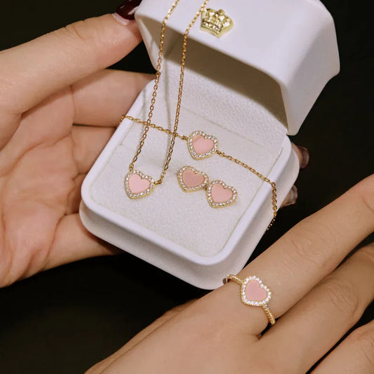 Heart stud earrings with pink enamel centers and diamond-like borders, gold-tone