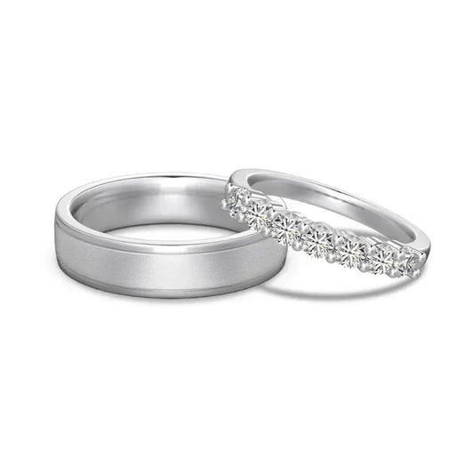 Silver-tone couple ring set with smooth band and CZ row accent on the other band