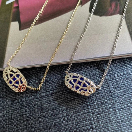 Gold pendant necklace with oval blue stones in lattice bezel settings