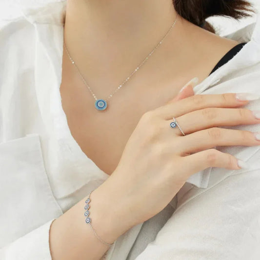 Wrist bracelet with small blue evil-eye charm circles on fine silver-tone chain