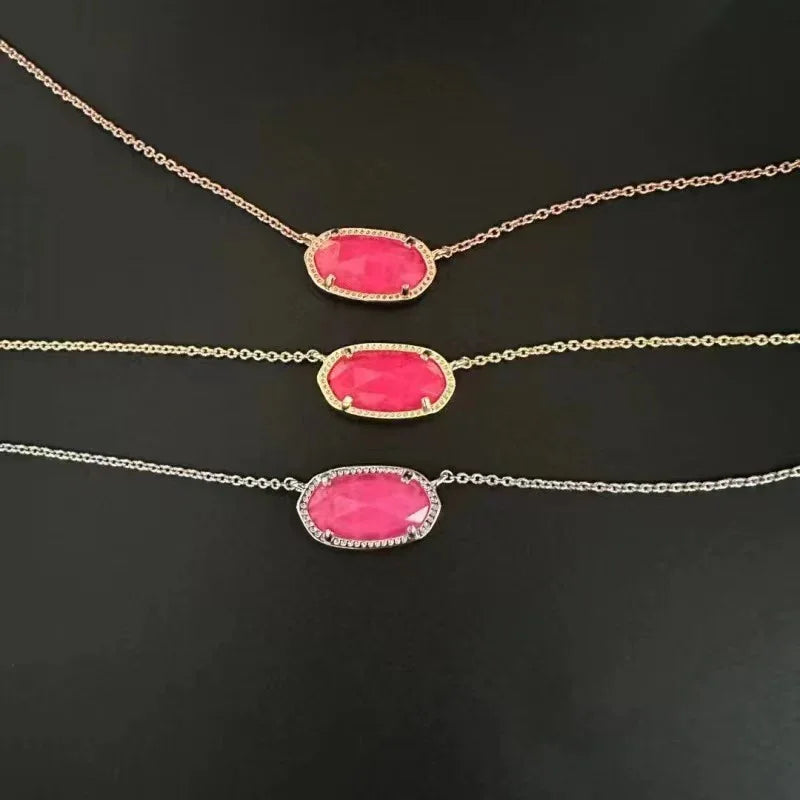 Teardrop pendant necklace with pink stone in gold-tone bezel and chain links