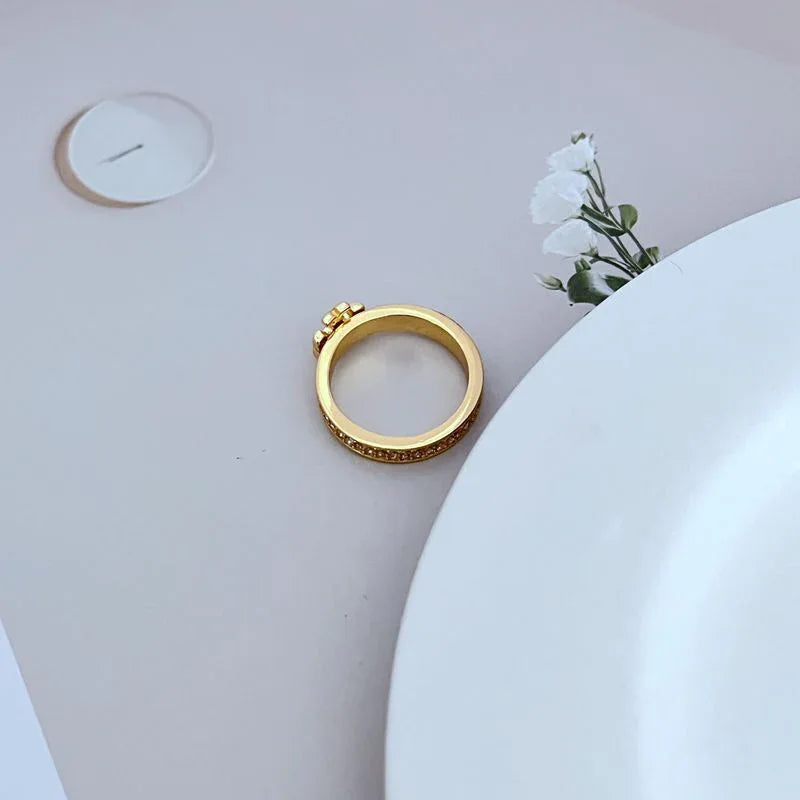 Gold pavé crystal ring with full-width crystal band and red centerpiece