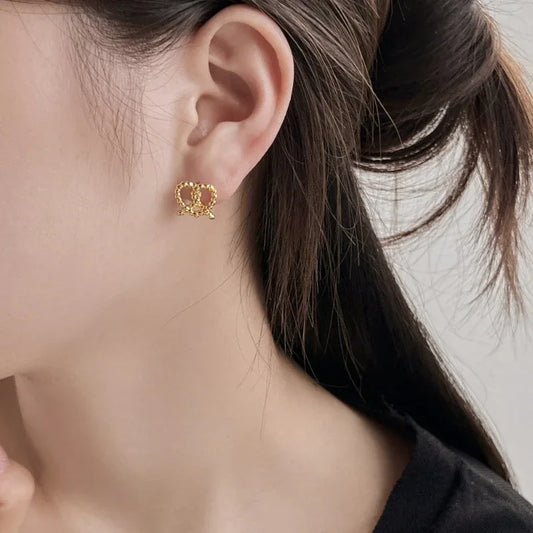 Gold heart stud earrings, small twisted loop heart shape on ear