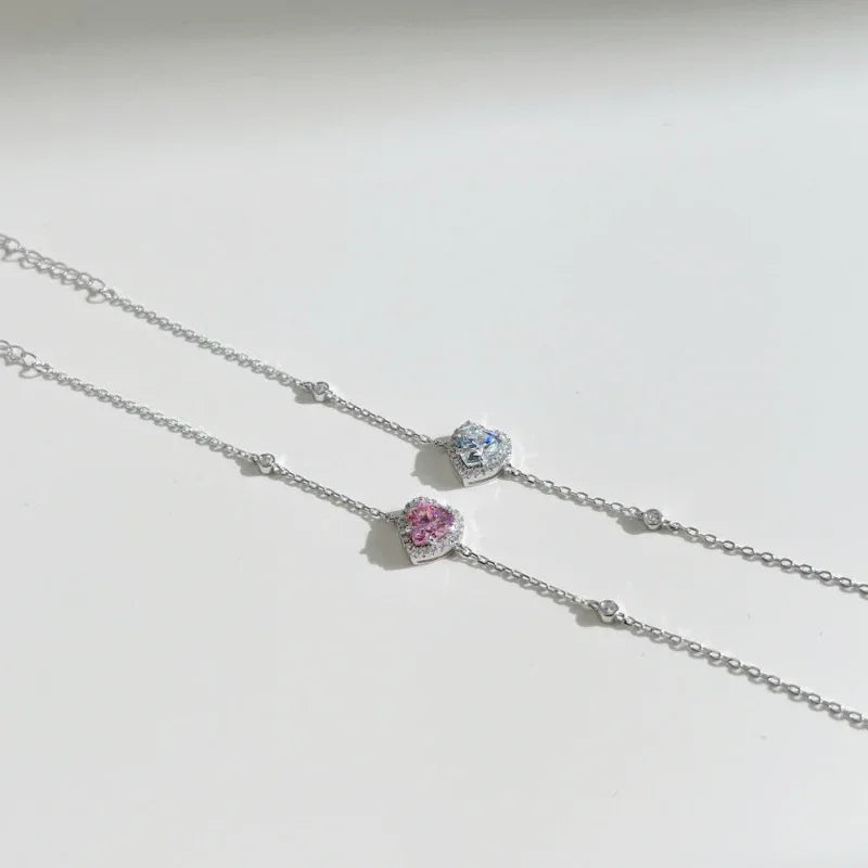 Sterling silver heart charm bracelet with pink and blue heart charms along chain