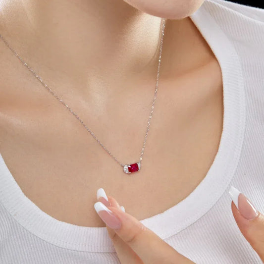 Silver CZ charm necklace with red heart-cut stone on a fine chain
