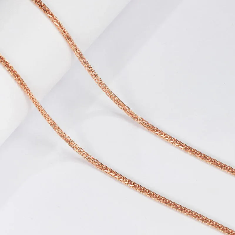 Rose gold braided wheat chain necklace, close-up of twisted links
