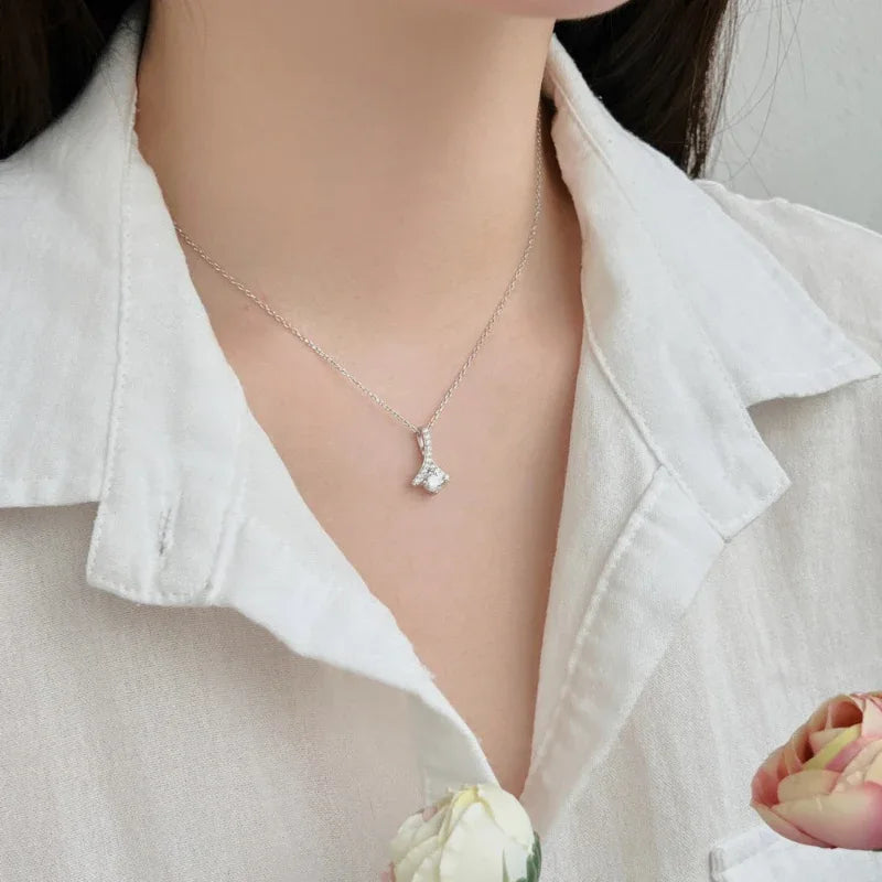 Teardrop CZ pendant necklace on thin chain resting at the collarbone