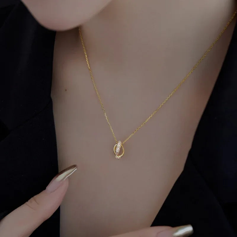 Gold heart pendant necklace with CZ stones and pink accents on a fine chain