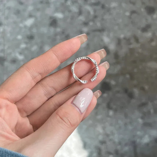 Sterling silver open ring with double-layer beaded geometric bands on finger
