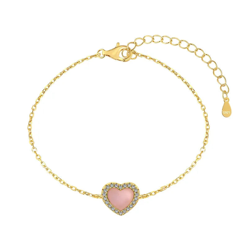 Gold-tone heart bracelet with pink enamel center and pavé border on link chain