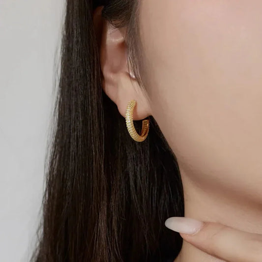 Gold-tone CZ pavé hoop earrings in a curved huggie style with stud backs