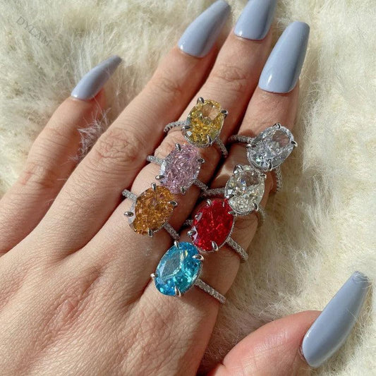 Sterling silver ring with oval yellow gemstone center and slim pave band on hand