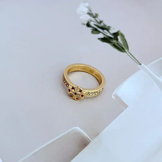 Gold pavé crystal ring with red stone cluster and raised geometric center