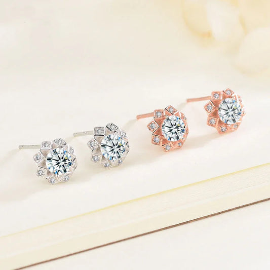 White gold diamond stud earrings with round center stone and small gem halo