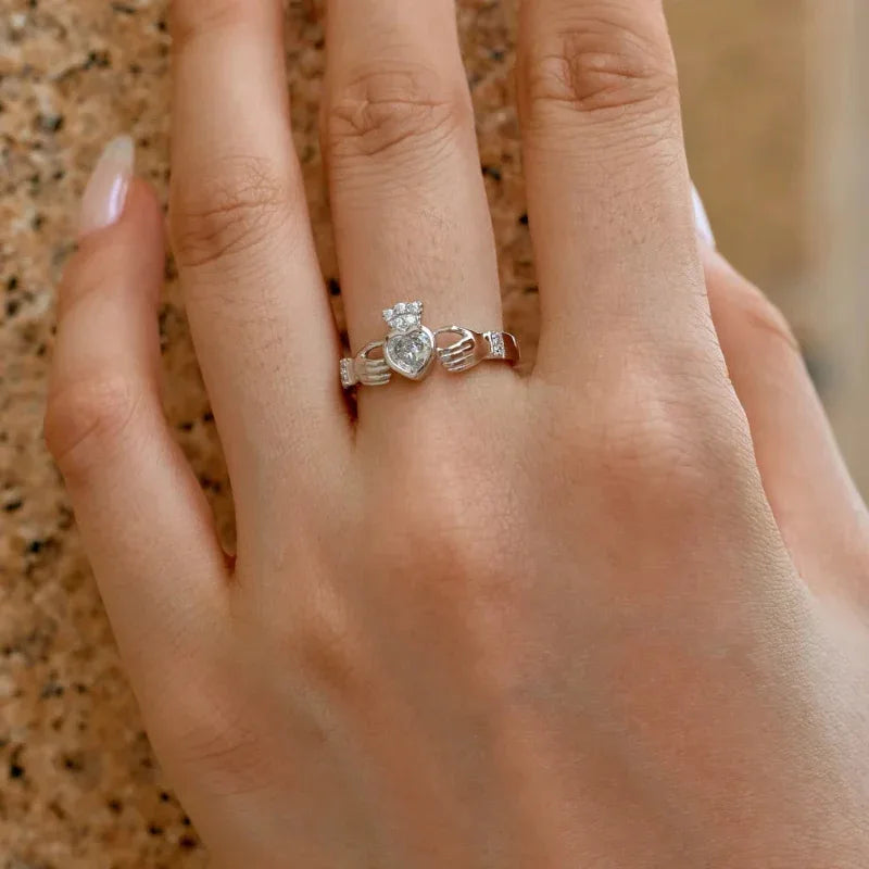 Silver CZ ring with heart-shaped center stone and raised side details