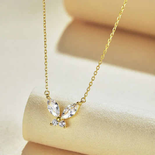Gold-tone butterfly pendant necklace with clear marquise stones and small round accents