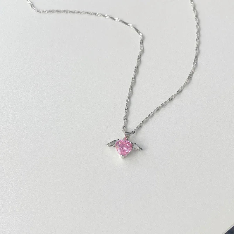 Pink CZ stone pendant with small angel wing details on silver chain