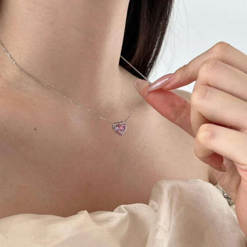 Heart CZ pendant necklace with pink heart stone on silver-tone chain on model