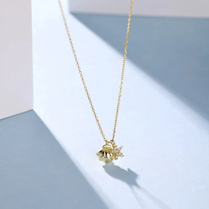 Gold-plated starfish and shell CZ pendant necklace, shell centerpiece