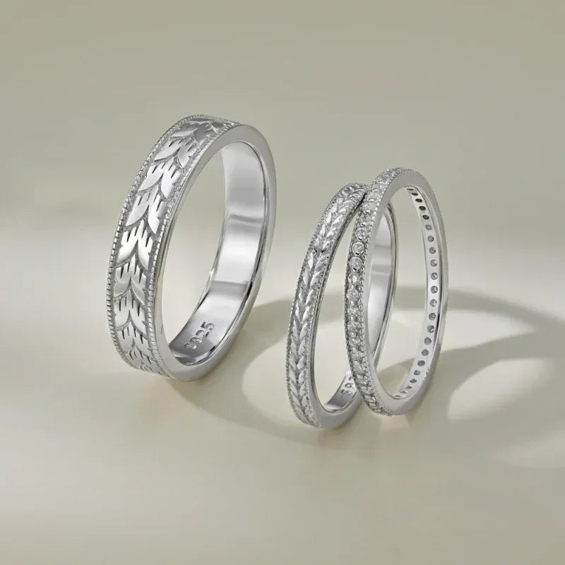 Rhodium silver couple engagement rings with engraved pattern and clear stone accents, two bands