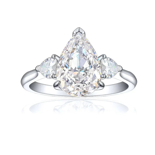 Silver pear-shaped engagement ring with clear center stone and two side stones