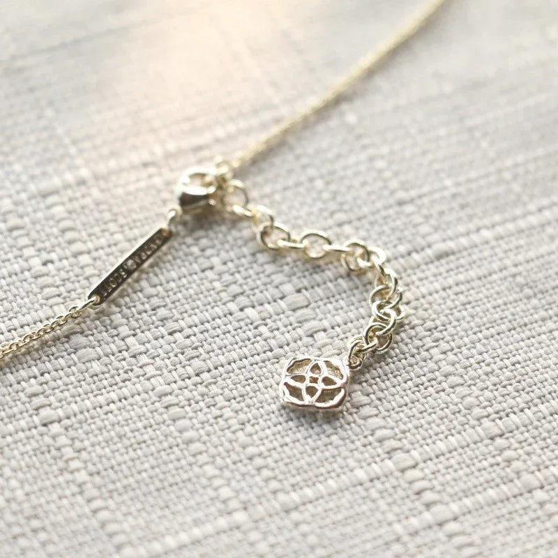 Preppy Kendra Scott necklace with small oval filigree charm on a linked chain