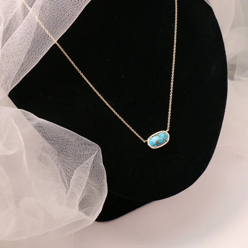 Statement pendant necklace with oval turquoise stone on gold chain