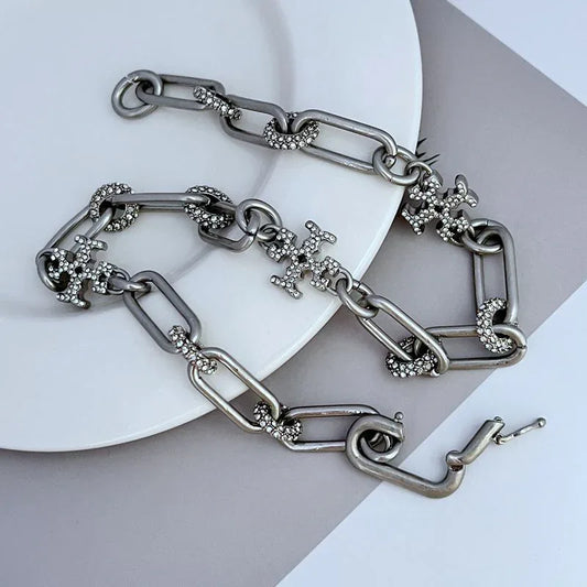 Crystal cross charm bracelet with linked oval chain and clasp, silver-tone