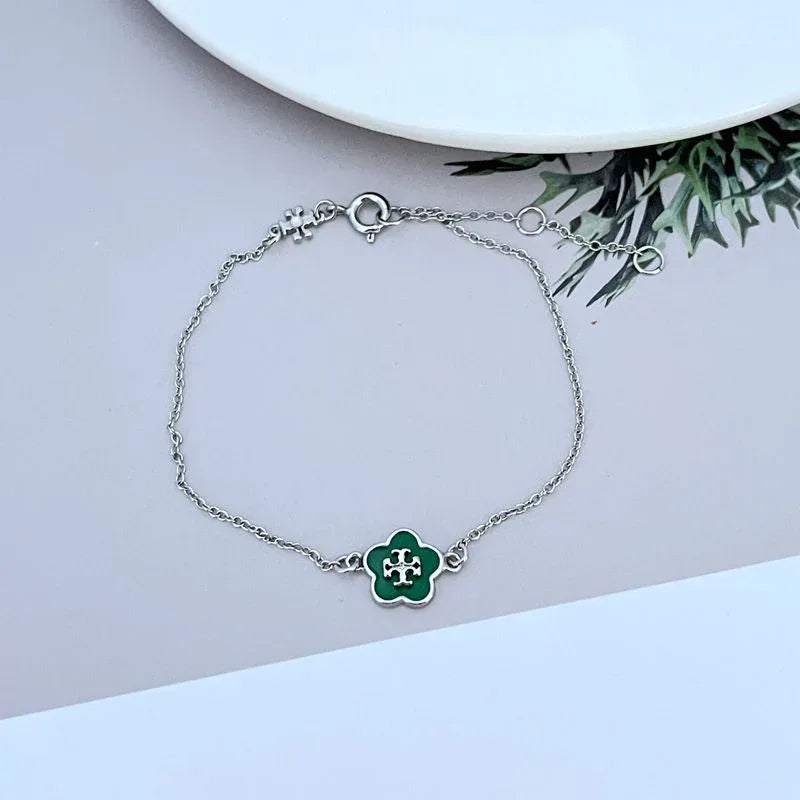 Silver-tone bracelet with green enamel flower charm and round chain links