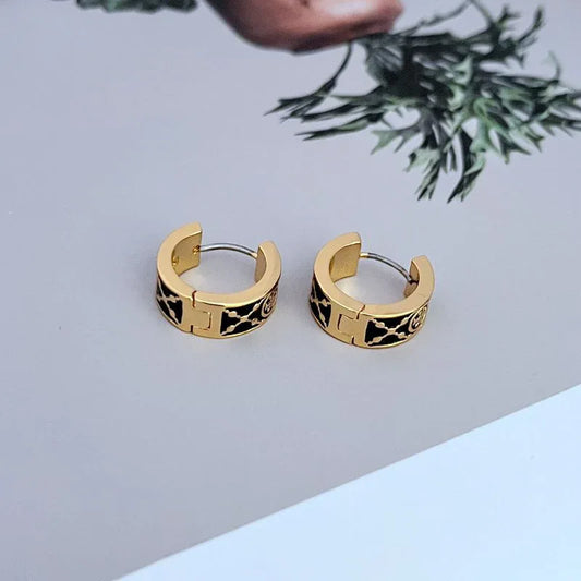 Gold hoop earrings with black enamel leopard pattern