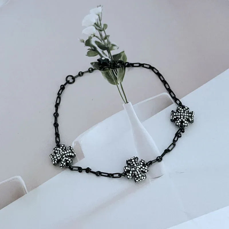 Black chain bracelet with three rhinestone clover charms and small star clasp