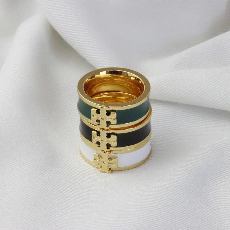 Gold-tone enamel ring with white, dark green, and black stripes and square logo detail