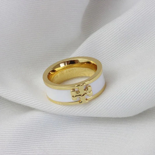 Gold-tone enamel ring with white enamel band and square logo detail