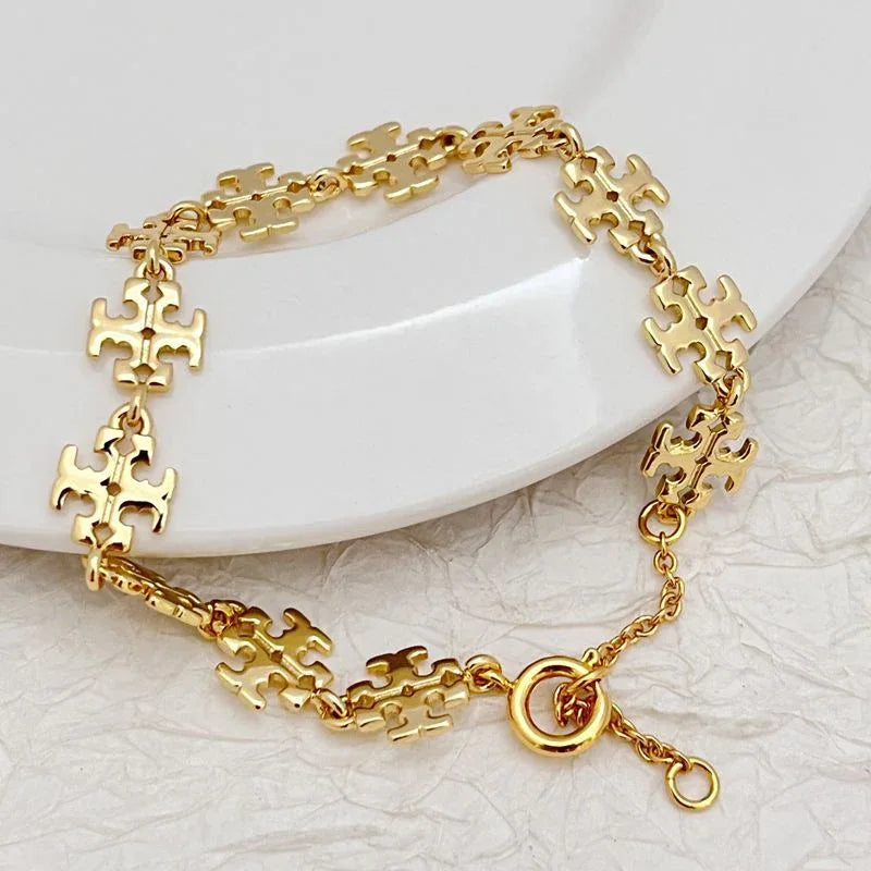 Gold link necklace with dangling chain segments and round ring charm clasp