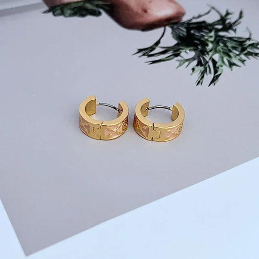 Gold hoop earrings with textured enamel and clasp post