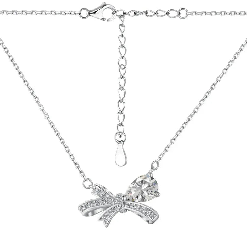 Silver-tone bow necklace with clear CZ heart pendant and link chain
