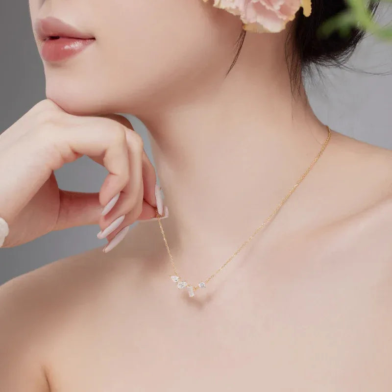 Gold-tone CZ heart pendant necklace with small heart center and side stones