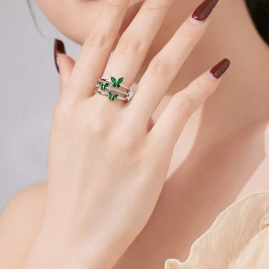 Adjustable butterfly eternity ring in silver with green stones and clear accents
